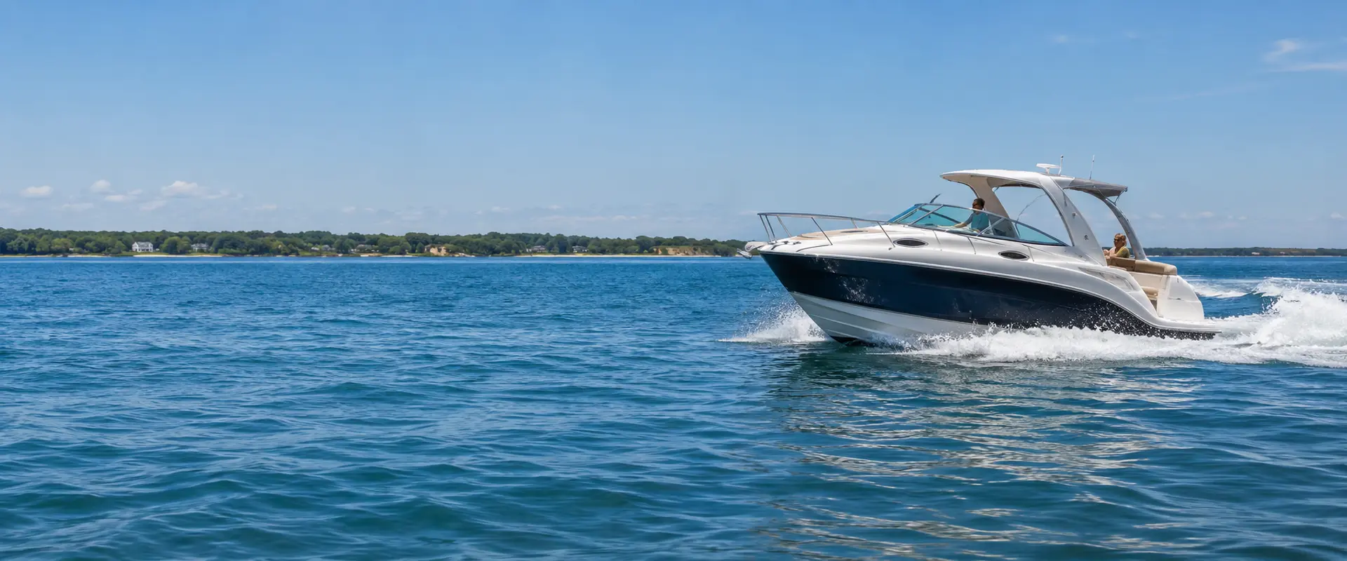 Recreational motorboat cruising on calm coastal water